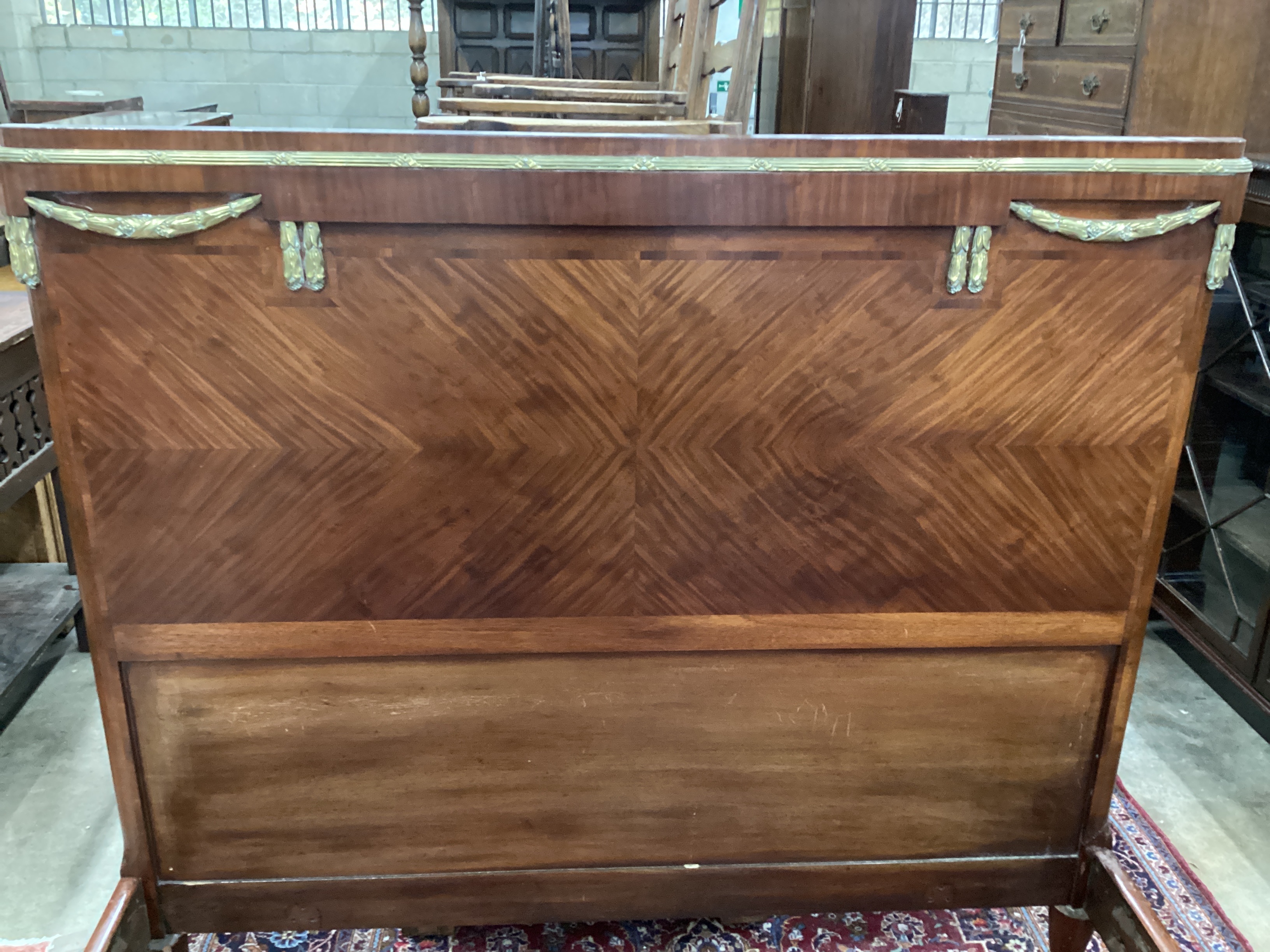 An early 20th century French walnut gilt metal mounted double bedframe, width 161cm, length 210cm, height 145cm